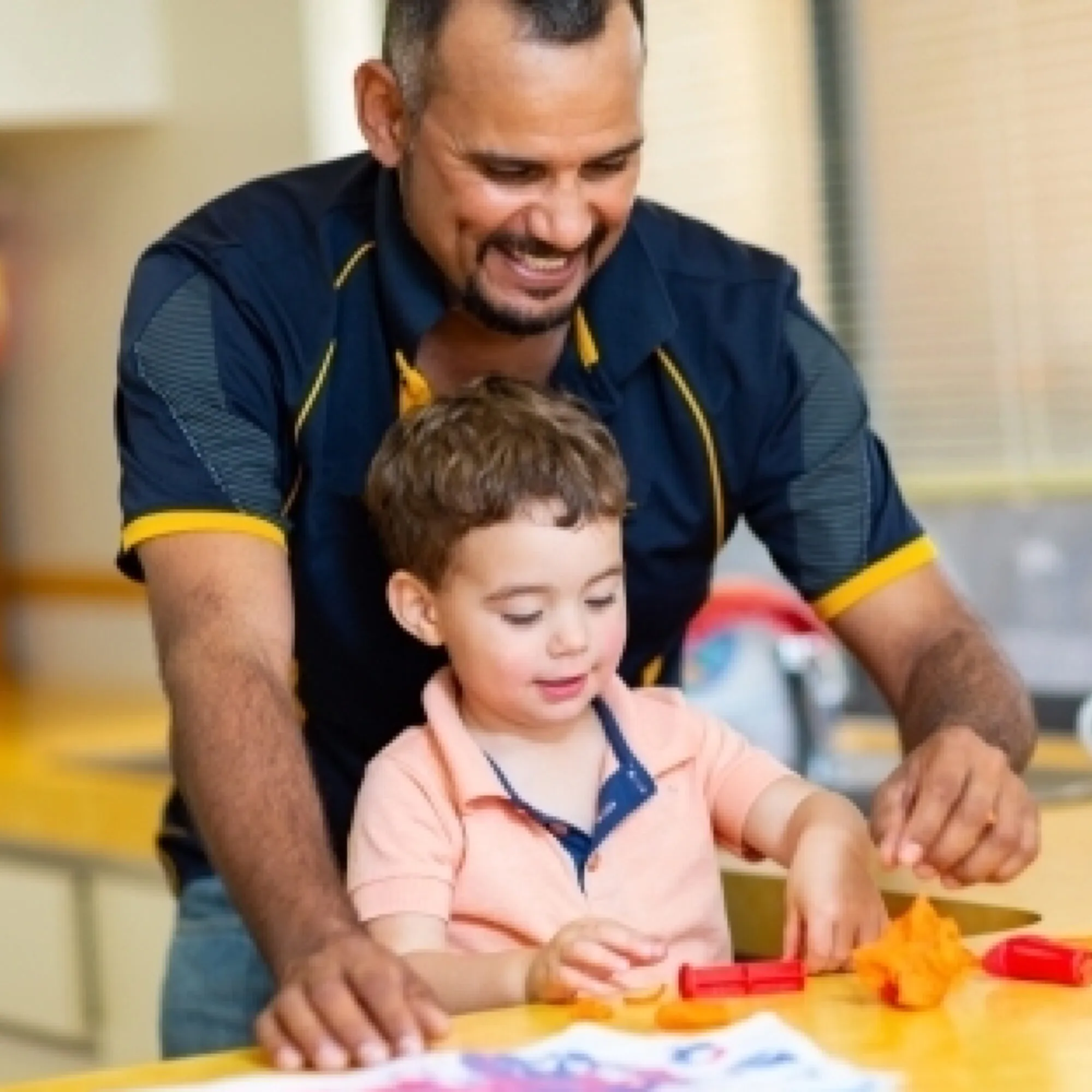 Father and toddler son playing with coloured dough in kitchen austockphoto 000114198